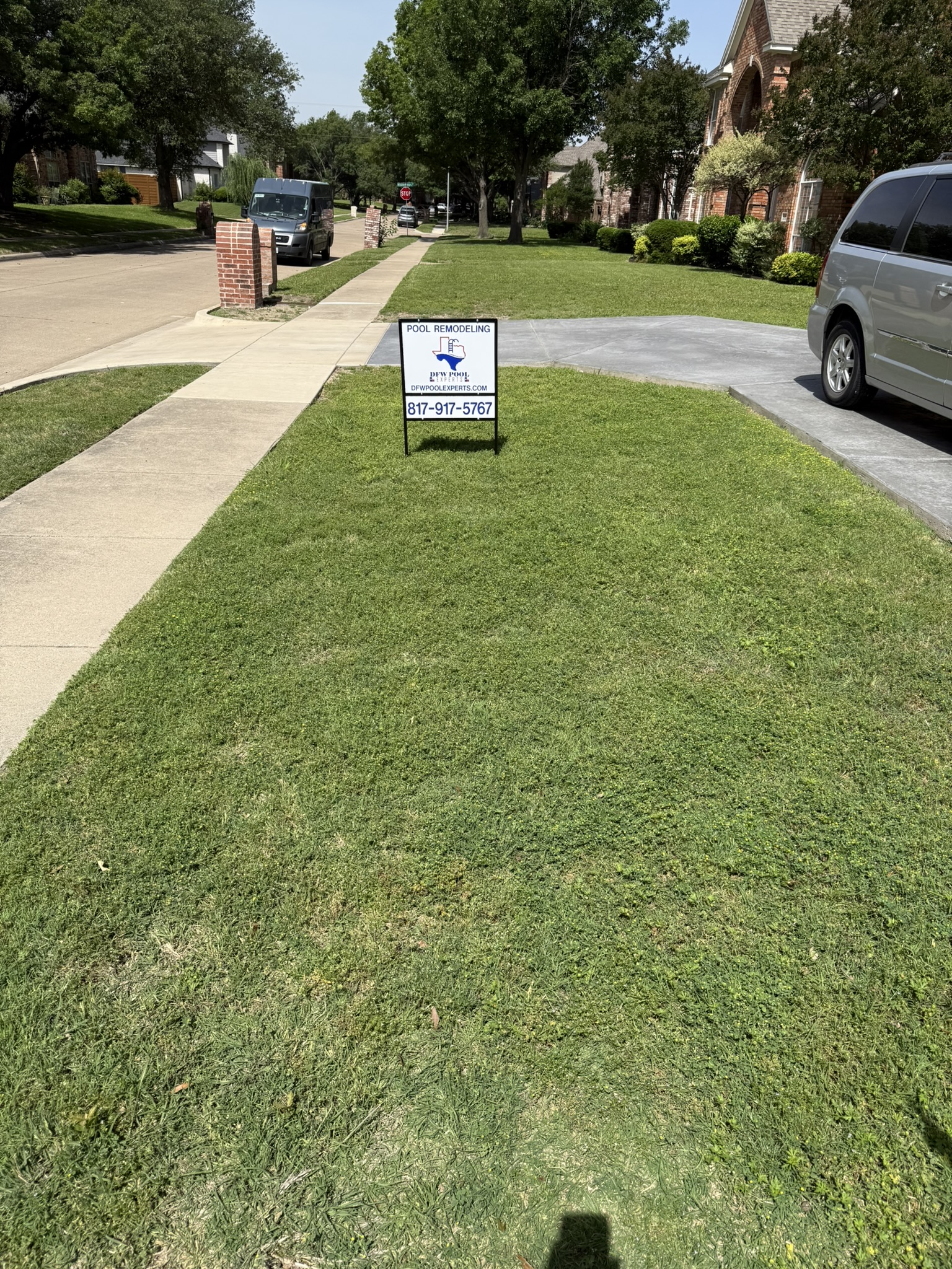 Sign in the yard advertising pool remodeling services with contact information.