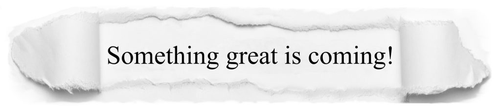 A torn paper strip with the text 'Something great is coming!' written in an elegant font.